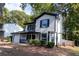 Charming two-story home with white siding, black shutters, and an attached garage at 1940 Matthew Way, Lithonia, GA 30058