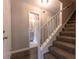 Carpeted staircase leading to the second floor, adjacent to a doorway with a bathroom view at 1940 Matthew Way, Lithonia, GA 30058