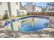 Sparkling blue kidney shaped pool surrounded by a unique stone border in a well-maintained yard at 5300 Willow Park Blvd, Atlanta, GA 30349