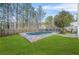 A well-manicured lawn surrounds a refreshing kidney shaped pool in a fenced backyard at 5300 Willow Park Blvd, Atlanta, GA 30349
