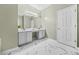 Bathroom with tiled floors, double vanity sinks and white cabinets at 5300 Willow Park Blvd, Atlanta, GA 30349