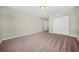 Empty bedroom featuring carpet flooring, a ceiling fan, and bi-fold door closet at 5300 Willow Park Blvd, Atlanta, GA 30349