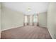 Empty bedroom with carpet flooring, lighting fixture, and curtains at 5300 Willow Park Blvd, Atlanta, GA 30349