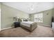 Well-lit bedroom featuring neutral walls, carpet flooring, and a ceiling fan at 5300 Willow Park Blvd, Atlanta, GA 30349