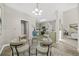 A dining room featuring a glass table with seating for four under a chandelier at 5300 Willow Park Blvd, Atlanta, GA 30349