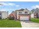 Charming two-story home featuring a brick facade, well-maintained lawn, and an attached two-car garage at 5300 Willow Park Blvd, Atlanta, GA 30349
