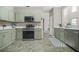 Well-lit kitchen featuring modern appliances, a stylish backsplash, and ample counter space at 5300 Willow Park Blvd, Atlanta, GA 30349