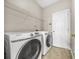 A laundry room with a white Samsung washer and dryer, with white door and wire rack at 5300 Willow Park Blvd, Atlanta, GA 30349