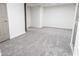 The basement features neutral paint, gray carpeting, and white baseboards and trim at 1030 Laurel Valley Sw Dr, Marietta, GA 30064