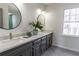 Bathroom with double sinks, modern vanity, and a large window at 1030 Laurel Valley Sw Dr, Marietta, GA 30064