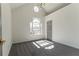 This bedroom has a vaulted ceiling, neutral paint color, large window, and gray carpet at 1030 Laurel Valley Sw Dr, Marietta, GA 30064