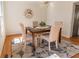 Bright dining room with wood floors, modern light fixture, and seating for four at 1030 Laurel Valley Sw Dr, Marietta, GA 30064