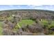 Aerial view of a beautiful property featuring a pond and a large grassy field at 1511 Broadnax Mill Road, Loganville, GA 30052