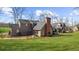 View of the home's rear exterior, showing an expansive yard with a chain link fence at 1511 Broadnax Mill Road, Loganville, GA 30052