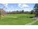 Expansive green backyard featuring a white fence and a long driveway at 1511 Broadnax Mill Road, Loganville, GA 30052