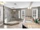 Elegant bathroom boasting a glass shower, dual sinks, neutral counters, and plenty of space at 1511 Broadnax Mill Road, Loganville, GA 30052