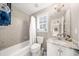 Well-maintained bathroom with a shower/tub combination, single sink, and natural light from a nearby window at 1511 Broadnax Mill Road, Loganville, GA 30052