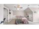 A bedroom with a ceiling fan and colorful LED accent lighting around the perimeter of the ceiling at 1511 Broadnax Mill Road, Loganville, GA 30052