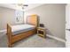 A bedroom with neutral carpet and walls and a wooden bed frame at 1511 Broadnax Mill Road, Loganville, GA 30052