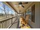 Inviting covered porch with ceiling fans and rocking chairs, perfect for relaxing and enjoying the outdoors at 1511 Broadnax Mill Road, Loganville, GA 30052