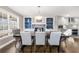 Elegant dining room with a table, built-in shelving, and natural light streaming through the windows at 1511 Broadnax Mill Road, Loganville, GA 30052