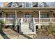 Attractive home showcasing its covered front porch with ceiling fans and elegant entry stairs at 1511 Broadnax Mill Road, Loganville, GA 30052