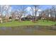 Beautiful home reflected in pond, surrounded by manicured lawn and mature trees at 1511 Broadnax Mill Road, Loganville, GA 30052