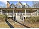 Attractive home showcasing its covered front porch with ceiling fans and elegant entry stairs at 1511 Broadnax Mill Road, Loganville, GA 30052