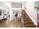 Grand foyer with hardwood floors, wooden staircase, and ample natural light from the adjacent rooms at 1511 Broadnax Mill Road, Loganville, GA 30052