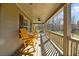 Inviting covered front porch with ceiling fan and wooden rocking chairs overlooking the property at 1511 Broadnax Mill Road, Loganville, GA 30052