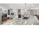 White and marble kitchen with view of fireplace and dining area at 1511 Broadnax Mill Road, Loganville, GA 30052