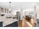 Open kitchen with white cabinets, marble countertop island, and stainless steel appliances at 1511 Broadnax Mill Road, Loganville, GA 30052