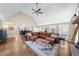 Open-concept living room with hardwood floors, ceiling fan, and view to the kitchen at 1511 Broadnax Mill Road, Loganville, GA 30052