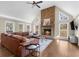 Inviting living room features a stone fireplace, large windows, and hardwood flooring at 1511 Broadnax Mill Road, Loganville, GA 30052