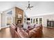 Living room featuring a stone fireplace and a large brown sectional sofa at 1511 Broadnax Mill Road, Loganville, GA 30052