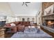 Spacious living room featuring a stone fireplace and a large brown sectional sofa at 1511 Broadnax Mill Road, Loganville, GA 30052