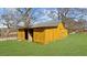 Charming wooden outbuilding with a metal roof in a green lawn setting at 1511 Broadnax Mill Road, Loganville, GA 30052