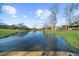 Picturesque pond reflecting the sky and surrounding landscape near a home at 1511 Broadnax Mill Road, Loganville, GA 30052