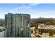 Exterior shot of modern high-rise apartment building with glass windows and balconies with a cityscape skyline at 250 Pharr Road Northeast Ne Rd, Atlanta, GA 30305