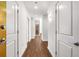 Hallway view featuring hardwood floors, white trim, and ample lighting at 250 Pharr Road Northeast Ne Rd # 1813, Atlanta, GA 30305