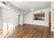 Open floor plan living room with wood floors, white walls, and kitchen view at 250 Pharr Road Northeast Ne Rd, Atlanta, GA 30305