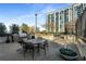 Outdoor patio with grill, dining table, seating, and landscaping near a high-rise building at 250 Pharr Road Northeast Ne Rd, Atlanta, GA 30305