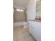 Bright bathroom featuring tiled walls, granite countertops, a soaking tub, and a large vanity mirror at 301 Fortune St, Atlanta, GA 30312