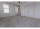 Spacious bedroom featuring plush carpet, ample natural light, and a double closet at 301 Fortune St, Atlanta, GA 30312