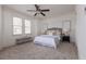 Comfortable bedroom with a ceiling fan, a plush bed, and natural lighting from two large windows at 301 Fortune St, Atlanta, GA 30312