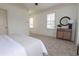 Bedroom featuring carpet, ceiling fan, windows, and stylish furniture at 301 Fortune St, Atlanta, GA 30312