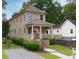 Charming two-story home with a inviting front porch, well-manicured landscaping, and a quaint brick staircase at 301 Fortune St, Atlanta, GA 30312