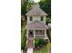 Aerial view showcases the home's facade, porch, well-kept lawn, and manicured hedges at 301 Fortune St, Atlanta, GA 30312