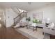 Bright living room featuring hardwood floors, modern decor, a staircase, and ample natural light at 301 Fortune St, Atlanta, GA 30312