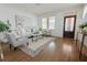 Bright living room with hardwood floors, a decorative front door, and a neutral color palette at 301 Fortune St, Atlanta, GA 30312